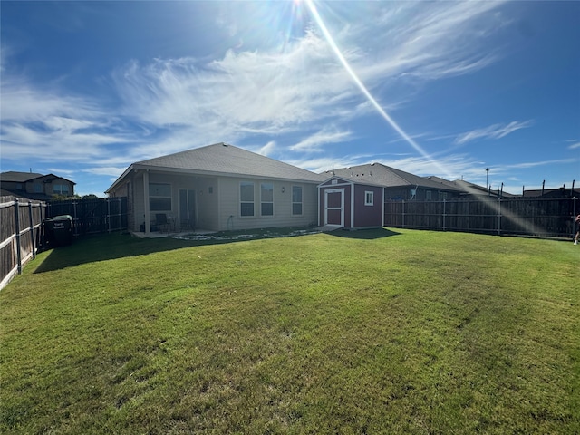 back of property featuring a storage unit and a lawn