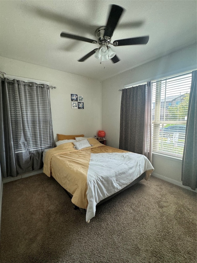 bedroom featuring ceiling fan and carpet