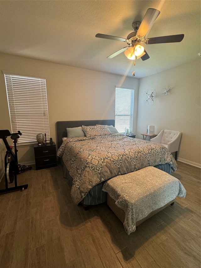 bedroom featuring ceiling fan and dark wood-type flooring