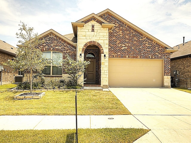 view of front of home with a garage, central air condition unit, and a front yard