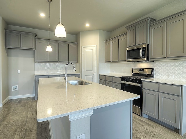 kitchen featuring gray cabinetry, sink, light wood-type flooring, and stainless steel appliances