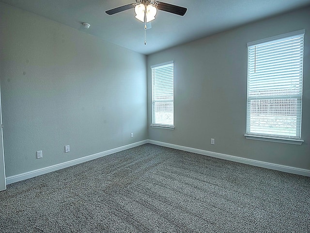 carpeted spare room with ceiling fan