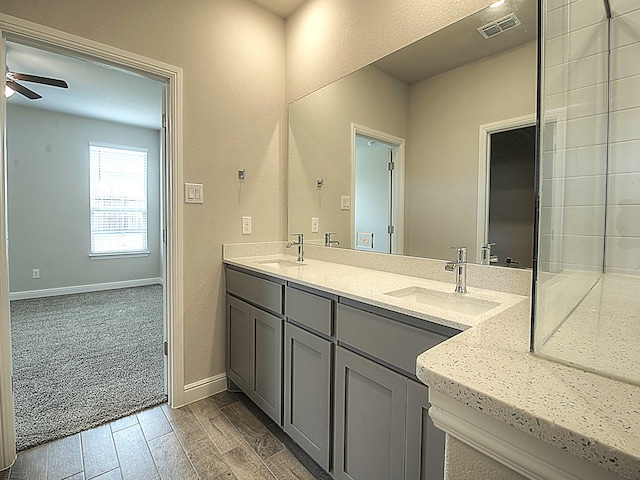 bathroom featuring double vanity and ceiling fan