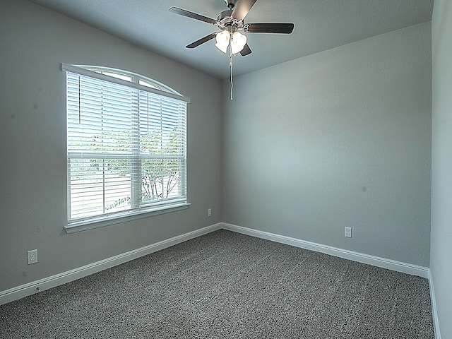 spare room featuring carpet flooring and ceiling fan