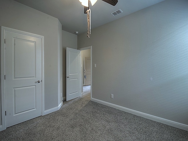 unfurnished bedroom featuring carpet flooring and ceiling fan