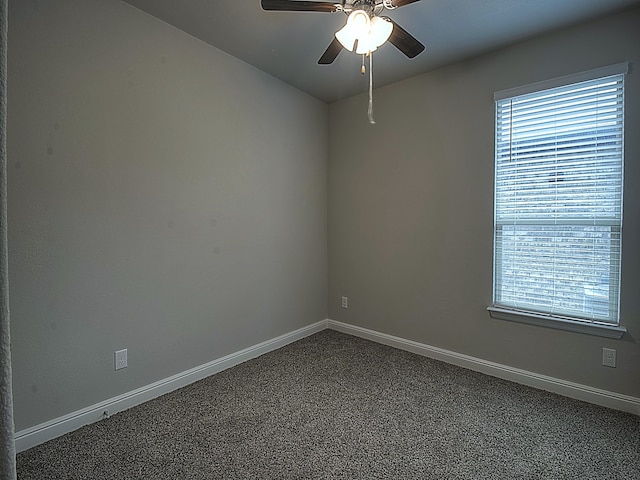 carpeted spare room with ceiling fan