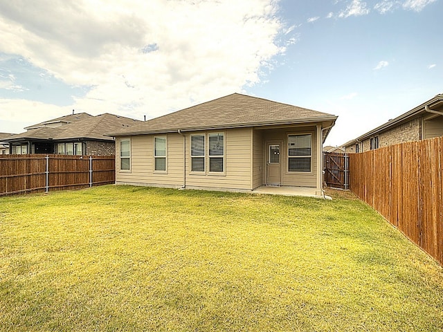 back of property featuring a patio and a yard