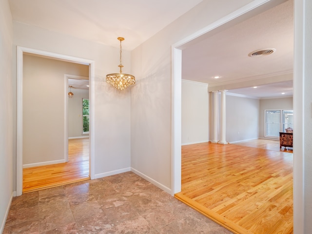 hallway with a notable chandelier and tile patterned floors