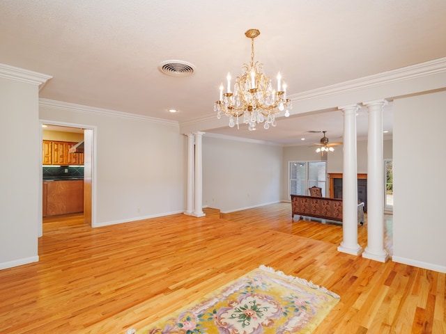 spare room featuring light hardwood / wood-style floors, ornamental molding, and ceiling fan with notable chandelier