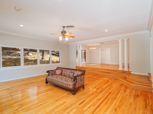 sitting room featuring decorative columns, ceiling fan with notable chandelier, crown molding, and light wood-type flooring