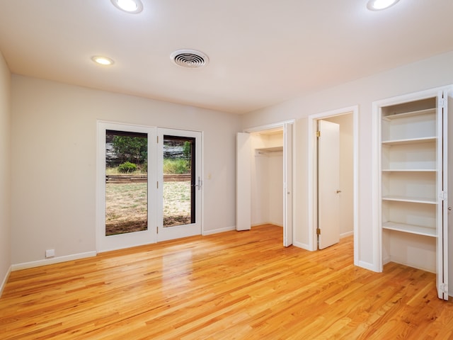 unfurnished bedroom featuring access to outside and light hardwood / wood-style flooring