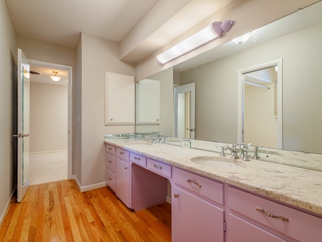 bathroom with hardwood / wood-style floors and dual bowl vanity