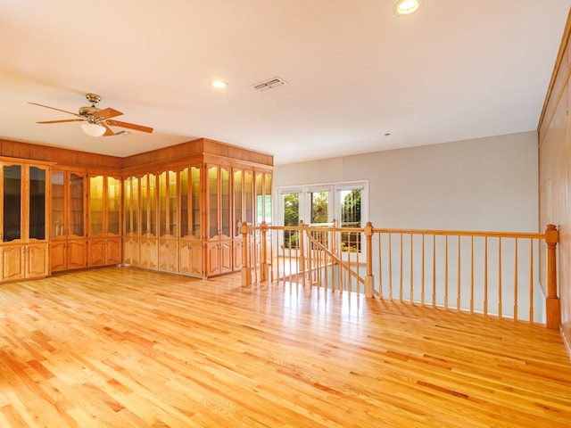 unfurnished room featuring light wood-type flooring and ceiling fan