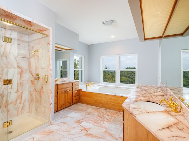 bathroom with tile patterned flooring, separate shower and tub, and vanity