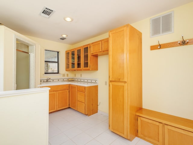 kitchen featuring sink and light tile patterned floors