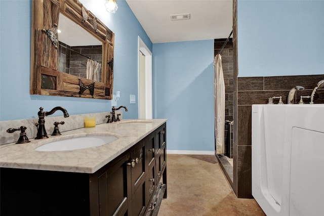 bathroom with walk in shower and vanity