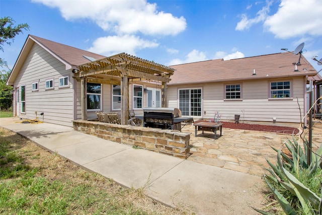 back of house featuring a patio, a pergola, a fire pit, and a jacuzzi