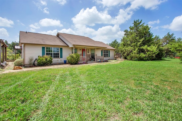 rear view of house with a porch and a yard