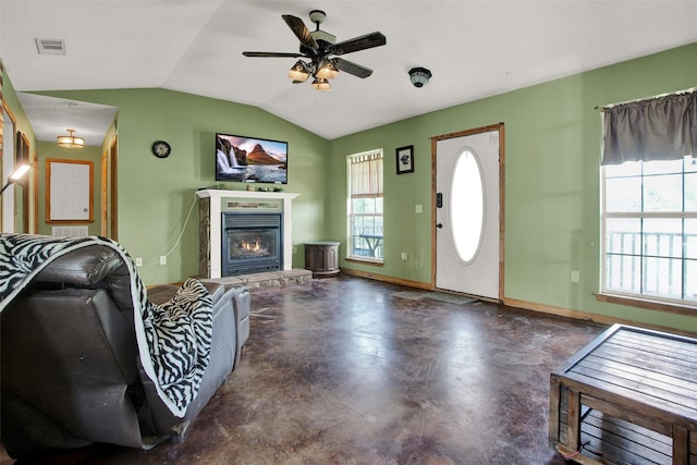 living room featuring ceiling fan and vaulted ceiling