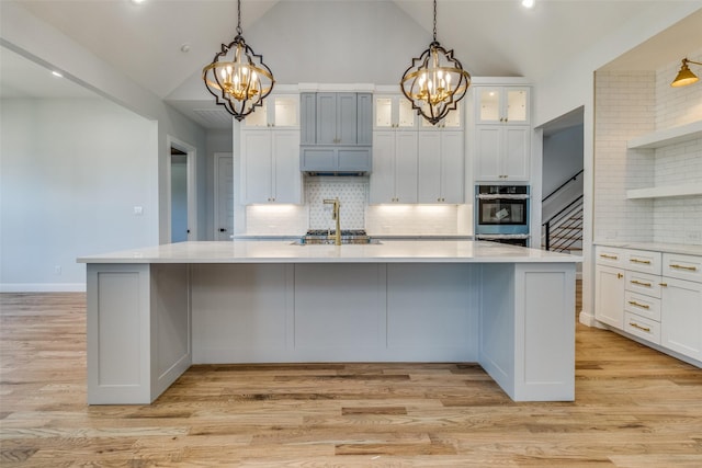 kitchen featuring pendant lighting, white cabinetry, and a chandelier