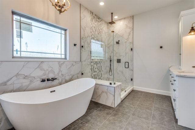 bathroom featuring vanity, plus walk in shower, and a chandelier