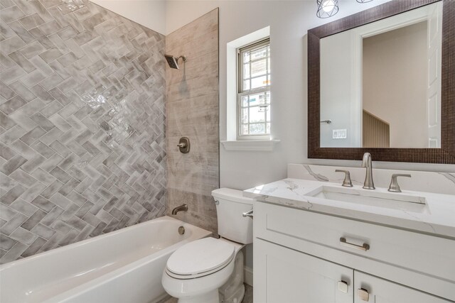 full bathroom with vanity, toilet, and tiled shower / bath