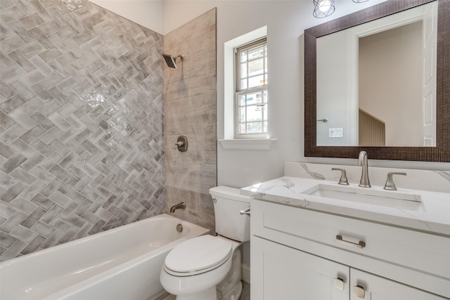 full bathroom featuring tiled shower / bath combo, vanity, and toilet