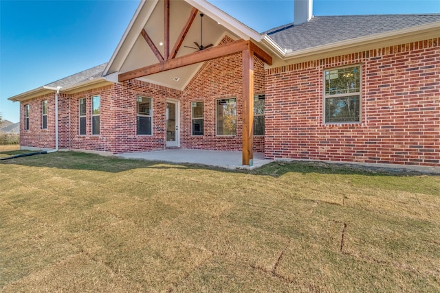 back of house with a lawn and a patio area