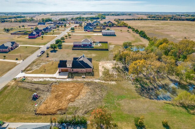 birds eye view of property with a rural view