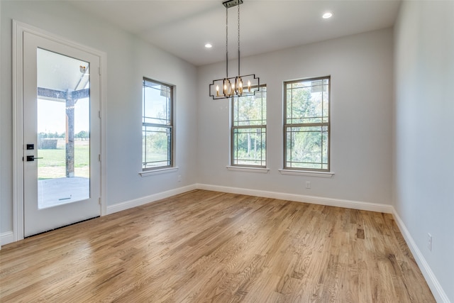 unfurnished living room featuring beamed ceiling, high vaulted ceiling, light hardwood / wood-style flooring, and a stone fireplace