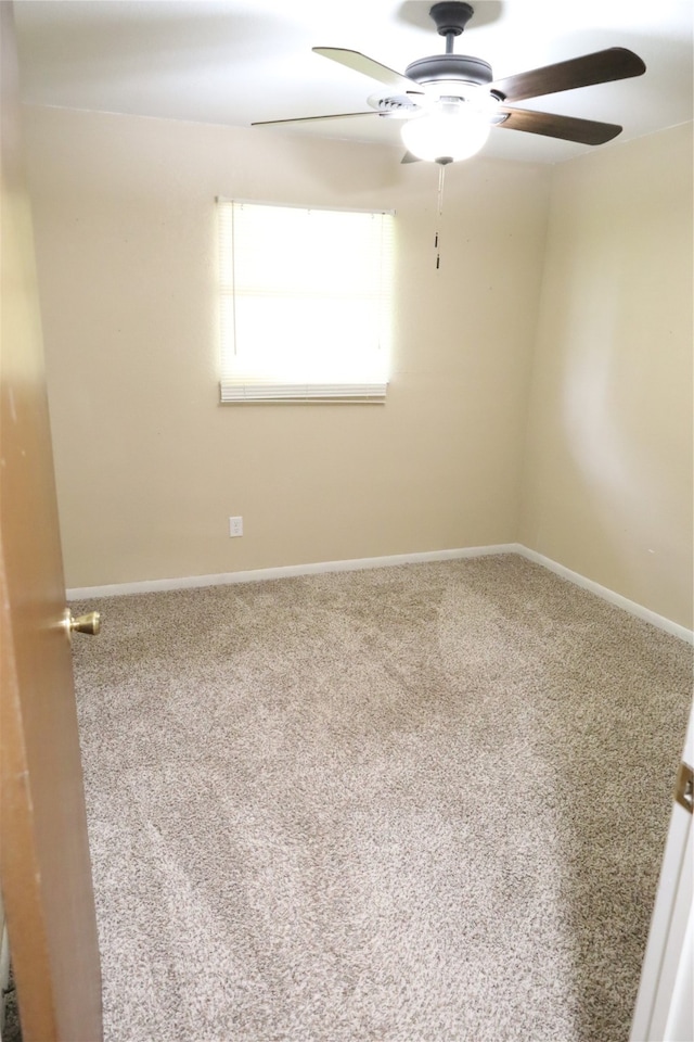 spare room with carpet flooring and ceiling fan