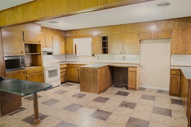 kitchen with white electric stove, stainless steel microwave, and light tile patterned floors