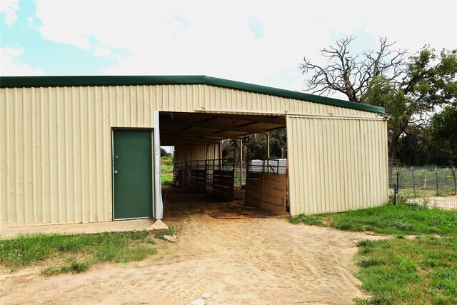 view of horse barn with an outbuilding