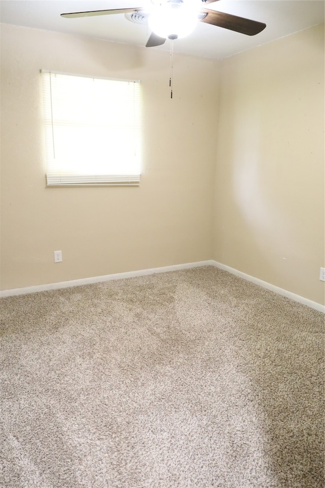 spare room with carpet flooring and ceiling fan