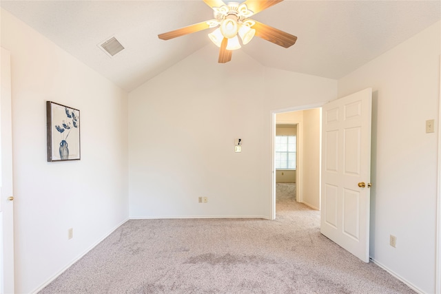 unfurnished room with ceiling fan, light colored carpet, and lofted ceiling