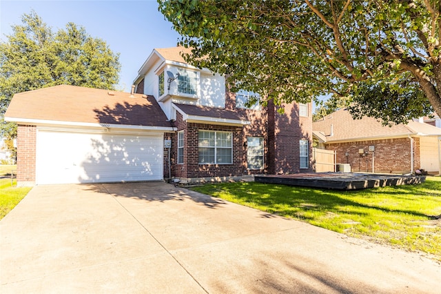 view of front facade featuring a front yard and a garage