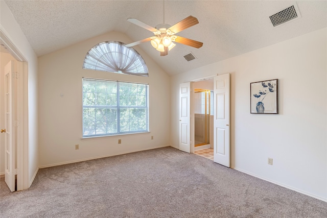 unfurnished bedroom featuring ceiling fan, lofted ceiling, light carpet, and multiple windows