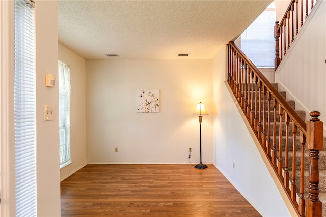 interior space with hardwood / wood-style flooring and a textured ceiling