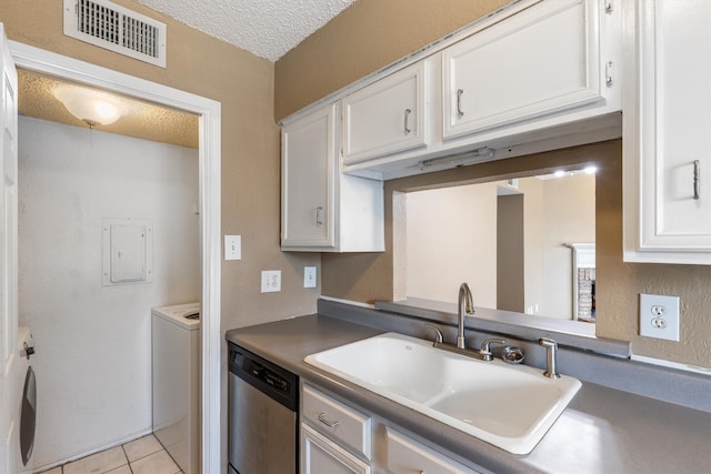 kitchen featuring separate washer and dryer, light tile patterned floors, white cabinets, dishwasher, and sink