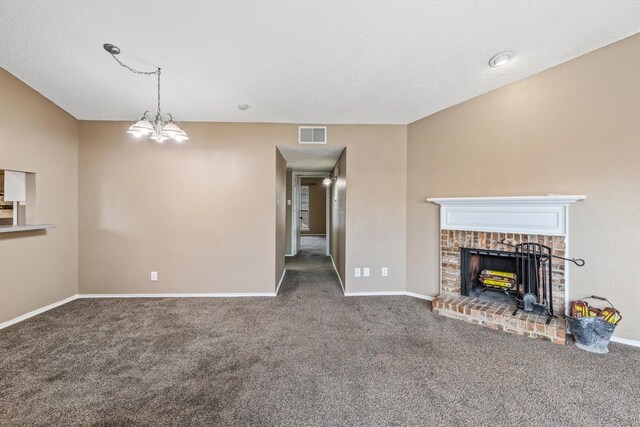 unfurnished living room with carpet flooring, a brick fireplace, and a chandelier