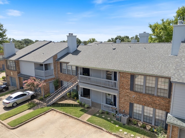 exterior space with a balcony and central AC