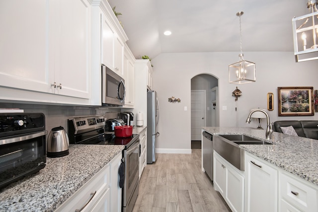 kitchen featuring light hardwood / wood-style floors, stainless steel appliances, backsplash, and white cabinets