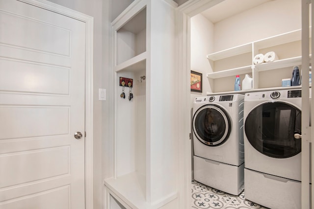 laundry area with separate washer and dryer and light tile patterned flooring