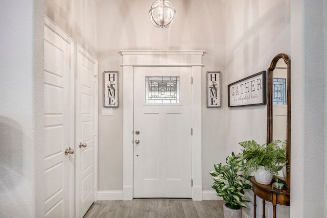 interior space featuring light hardwood / wood-style floors and a chandelier