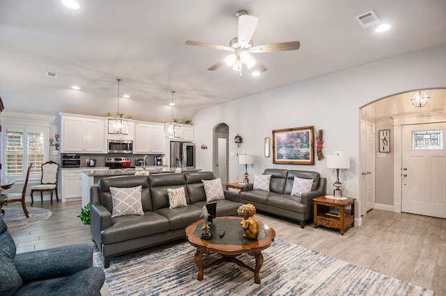 living room with light hardwood / wood-style flooring, sink, and ceiling fan