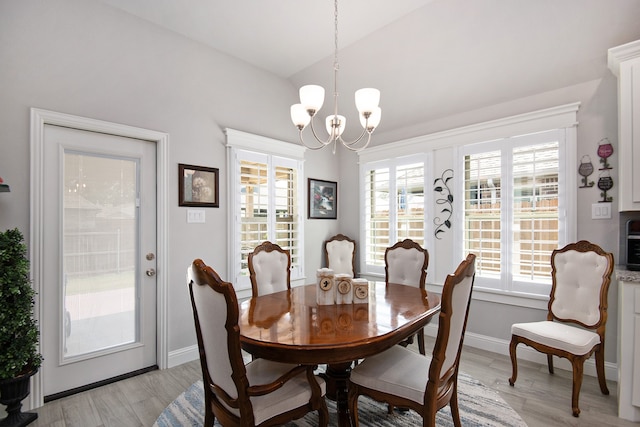 dining room featuring light hardwood / wood-style flooring and a chandelier