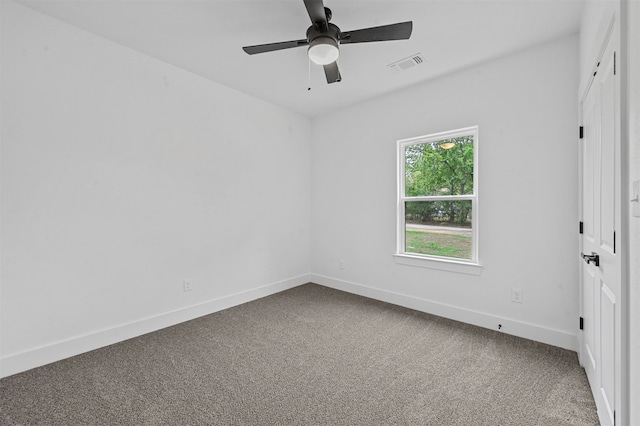 carpeted spare room featuring ceiling fan