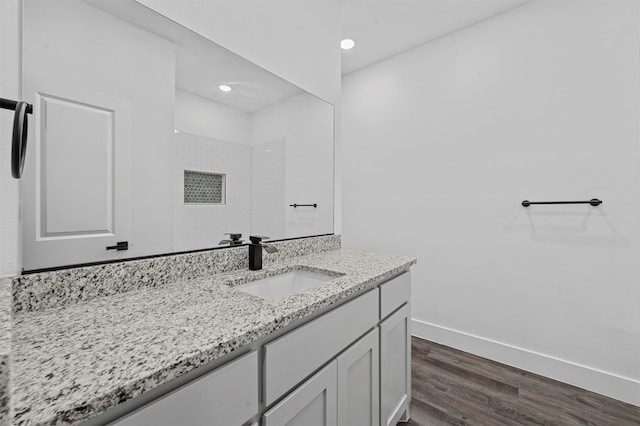 bathroom featuring vanity, hardwood / wood-style floors, and a shower