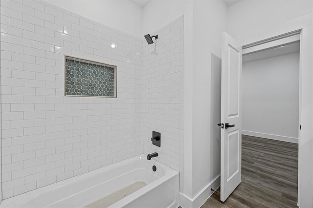 bathroom featuring hardwood / wood-style floors and tiled shower / bath combo