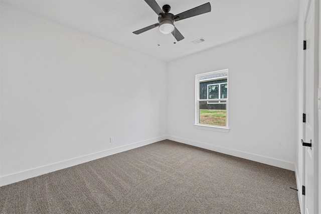 carpeted spare room featuring ceiling fan